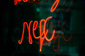 NYC neon sign on glass background, dark mood look.