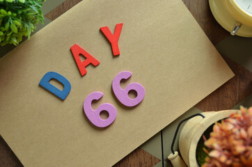 Aufkleber - Day 66, cover design in natural concept with the alphabet on brown notebook on the wooden table for a background.