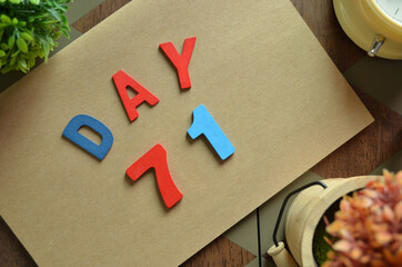 Aufkleber - Day 71, cover design in natural concept with the alphabet on brown notebook on the wooden table for a background.