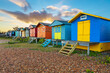 © robertharding - Colourful beach huts on shingle beach at sunrise, Whitstable, Kent, England