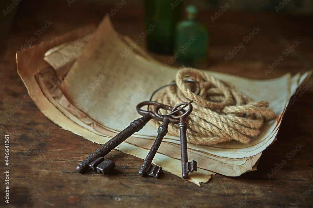 Antique objects of a treasure hunter, traveler and discoverer - ancient manuscripts, keys to chests. The concept of adventure, prison escape, good luck and romance. - obrazy, fototapety, plakaty 
