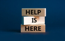 Help Is Here And Support Symbol. Wooden Blocks With Words 'Help Is Here' On Beautiful Grey Background. Business, Support, Help Is Here Concept. Copy Space.