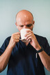 © karrastock - Studio portrait of doctor drinking coffee, healthcare worker
