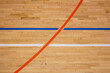 © Serg Po - The worn wooden floor of the sports basketball hall with colorful marking lines.