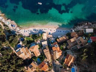 Wall Mural - Beautiful beach with turquoise waters near authentic villas. Corfu, Greece. Top-down view.