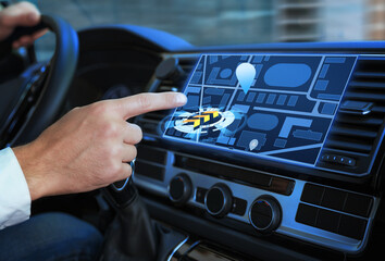 Canvas Print - Man using navigation system while driving car, closeup