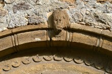 The Figure Of A Man Carved In Stone Above The Door
