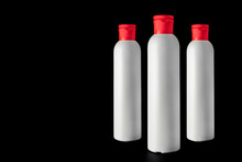 White Plastic Shampoo Bottle With A Red Cap On A Gradient Blue And Black Background. Mock-up. Copy Space