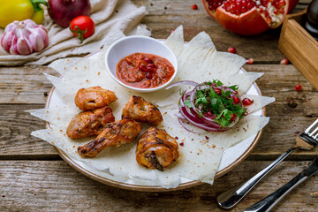 Canvas Print - chicken kebab on board with red onion and tomato sause on old wooden table