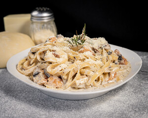 Wall Mural - Delicious chicken parmesan pasta, served on a white plate.