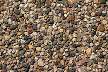 Top View Close-up Texture Background Of A Vintage Exposed Aggregate Stone Patio Surface In Bright Natural Sunlight
