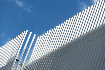 Wall Mural - contemporary white grey metal architecture on blue sky background.