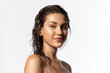 © deniskomarov - Beautiful young woman with clean perfect glowing skin, wet hairs. Portrait of smiling girl with bare shoulders on gray studio background. Skincare and wellness. Natural woman beauty.