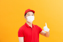 Courier Or Deliveryman In Mask And Gloves Showing Thumbs Up Sign