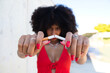 beautiful afro american woman breaking a cigarette and looking at the camera. Campaign on smoking cessation awareness. Health concept. Smoke-free world