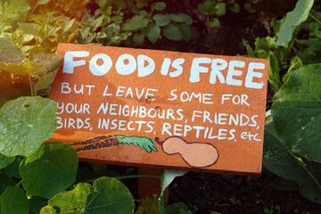 Community garden, Food is free sign in vegetable garden