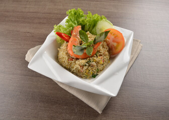 stir fried egg rice with seafood tiger prawn in thai green curry sauce in wood background asian halal menu