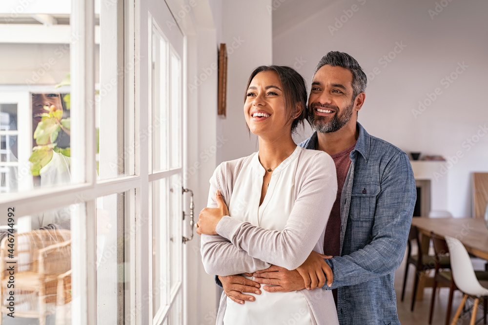 Mature multiethnic couple thinking about their future family - obrazy, fototapety, plakaty 