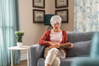 © Rido - Senior woman reading book at home