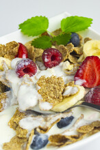 Close Up Of A Muesli On A Spoonful With Fruit, Banana, Raspberry, Strawberry, Berries