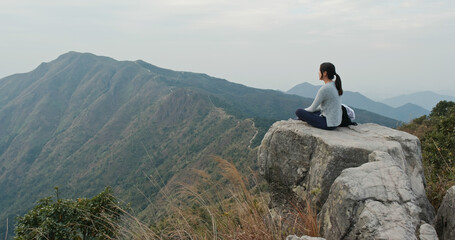 Canvas Print - Woman sit on the top of the mountain