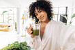 © Daniel - Young african american woman taking selfie drinking green juice reusable bamboo straw