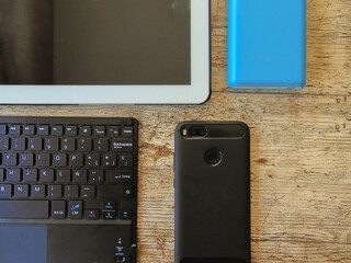 Sticker - Top view of Office table with tablet, keyboard and portable battery.