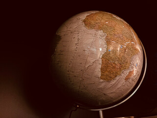 earth old vintage globe highlighting africa continent in warm lighting and showing africa and surrou