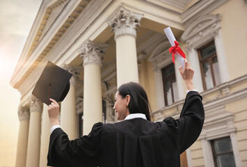 Poster - Student with diploma after graduation ceremony outdoors, low angle view