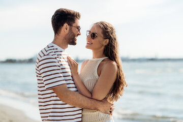 Wall Mural - summer holidays and people concept - happy couple on beach