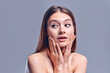 © Olena Apetroaiei - Woman surprise holds cheeks by hand .Beautiful girl with clean fresh skin .Expressive facial expressions. Cosmetology , beauty and spa . Face care treatment