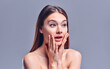 © Olena Apetroaiei - Woman surprise holds cheeks by hand .Beautiful girl with clean fresh skin .Expressive facial expressions. Cosmetology , beauty and spa . Face care treatment