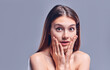 © Olena Apetroaiei - Woman surprise holds cheeks by hand .Beautiful girl with clean fresh skin .Expressive facial expressions. Cosmetology , beauty and spa . Face care treatment