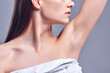 © Olena Apetroaiei - Armpit epilation, lacer hair removal. Young woman holding her arms up and showing clean underarms, epilation on smooth clear skin .Beauty portrait. Skin care.