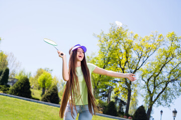 Sticker - Photo of sweet adorable woman wear green clothes smiling playing badminton outdoors urban city park