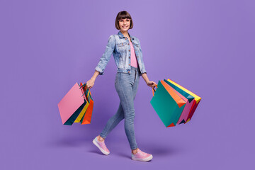 Canvas Print - Full size profile photo of funny millennial brunette lady hold bags go wear spectacles jeans shirt isolated on purple background