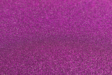 Magenta glitter texture background. Glowing defocused backdrop.