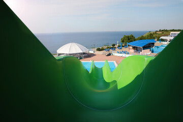 Wall Mural - Green slide in water park on sunny day