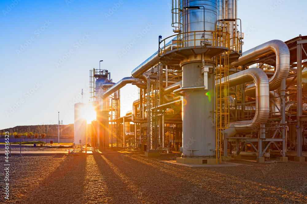 View of a gas refinery plant illuminated at sunset Stock Photo | Adobe ...
