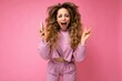 © Ivan Traimak - Photo of attractive crazy amazed surprised young woman wearing casual stylish clothes standing isolated over background with copy space holding and using mobile phone looking at camera