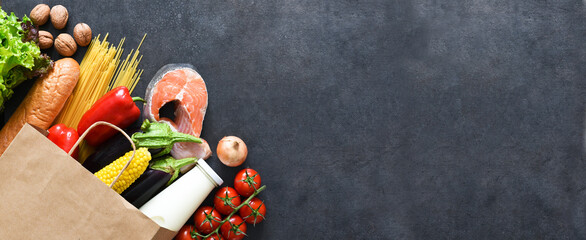 Shopping in a paper bag: salmon, pepper, eggplant, nuts, bread, eggs. Food delivery. Advertising. Supermarket.