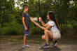 © New Africa - Woman applying insect repellent on her son's arm in park. Tick bites prevention