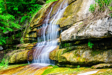 Wall Mural - Beautiful waterfall on small river in a park