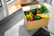 online ordering of products from the online store on the table in the kitchen. vegetables and fruits in a cardboard box on the table top view.