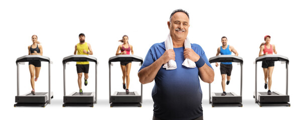 Sticker - Mature man with a towel around his neck standing in front of people on treadmills