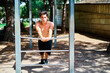 © Cavan Images - Boy practicing calisthenics in the park