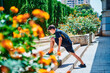 © Cavan Images - Boy doing stretching before running in the park