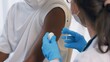 Young man visits skillful doctor at hospital for vaccination . Covid 19 and coronavirus vaccination center service concept .