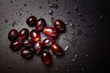 © Cavan - Close up of red grapes on black background with copy space.