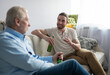 © Cavan Images - Positive grandson talking with grandfather in weekend
